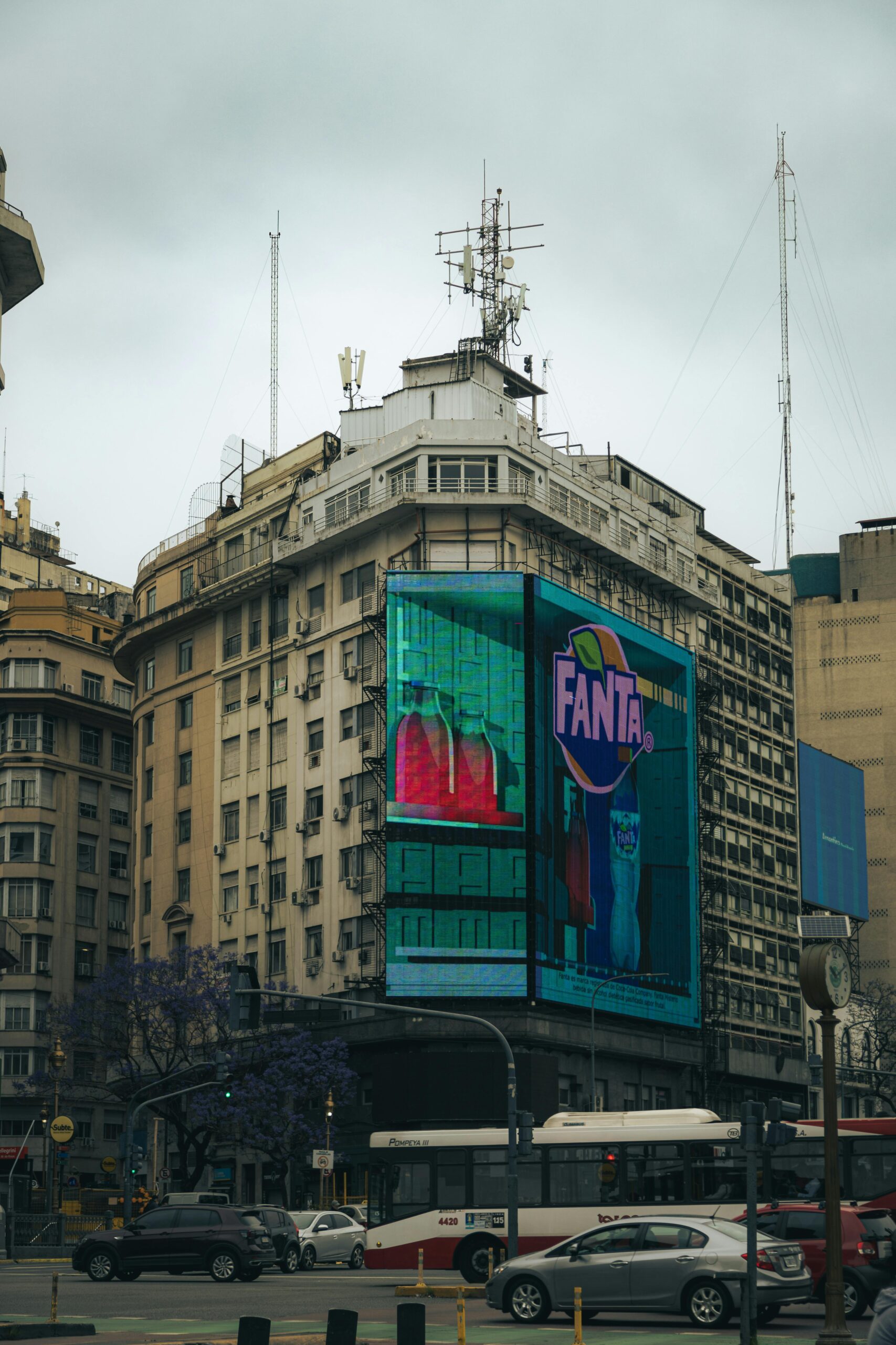 Busy Buenos Aires street scene featuring a large advertisement on a historic building.